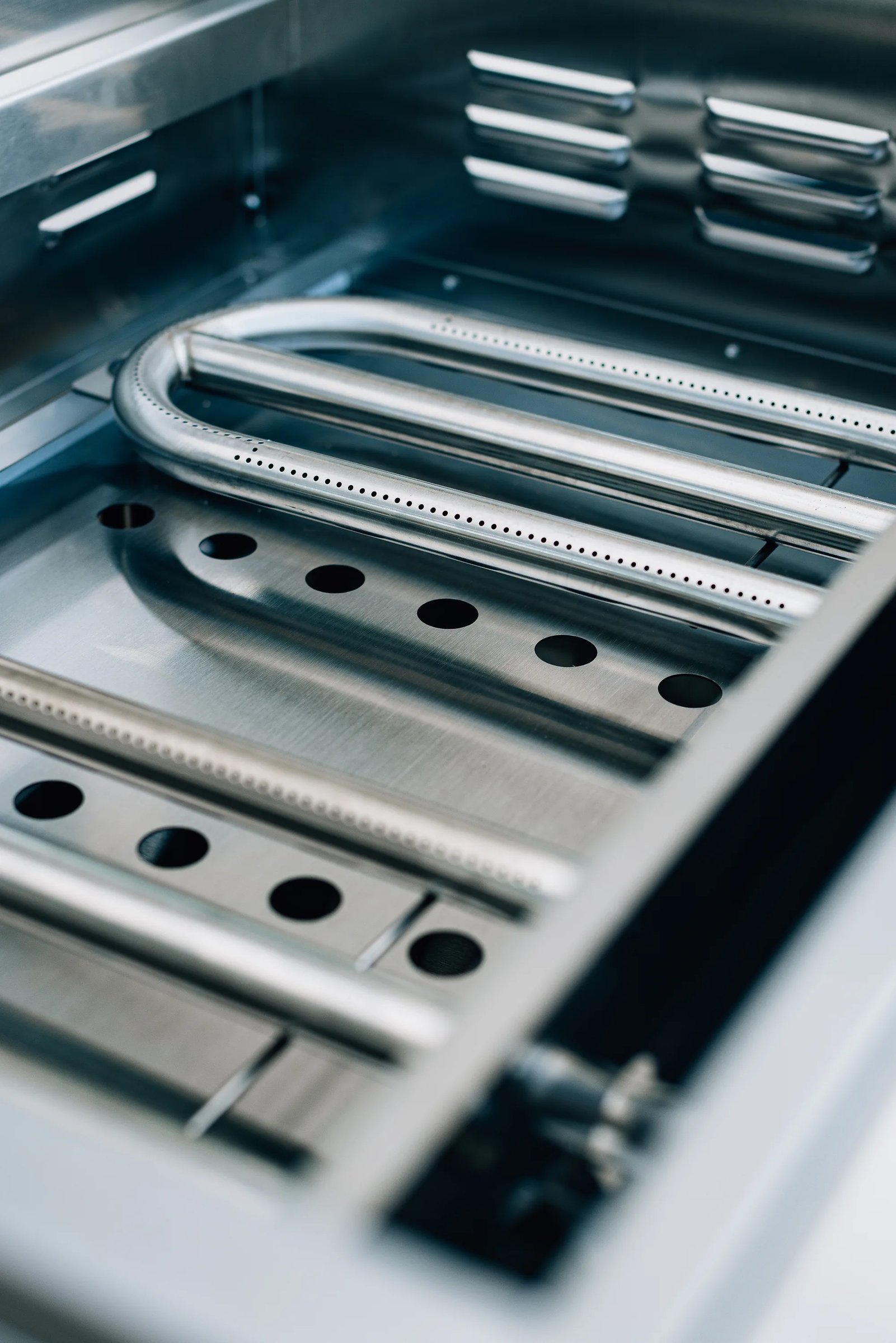 Firebox interior of the Summerset 30-inch Griddle Pro built-in gas griddle with the U-tube burner installed beneath the cooking surface