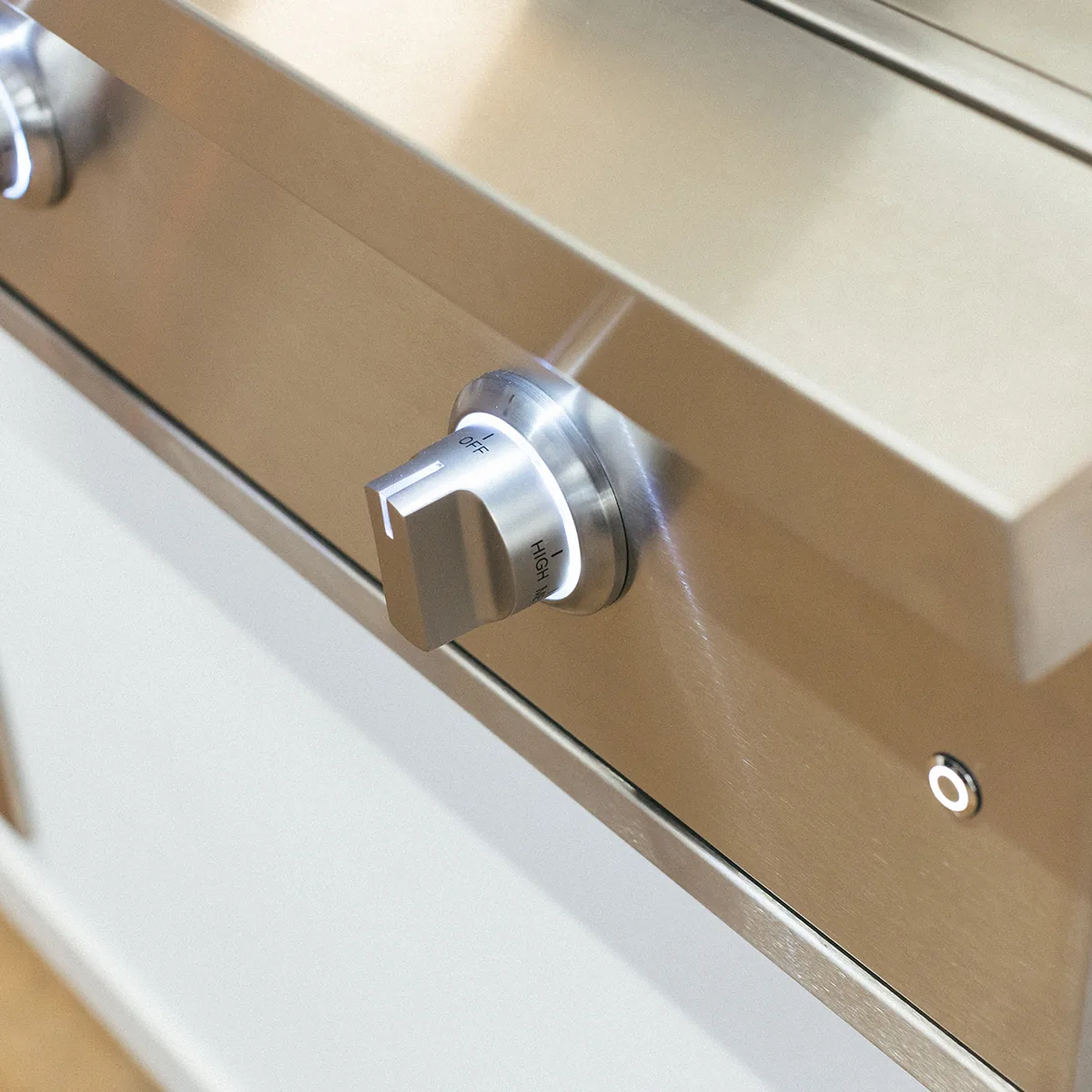Close-up of the illuminated LED control knob on the Summerset GRID30 30-inch gas griddle, marked OFF and HIGH